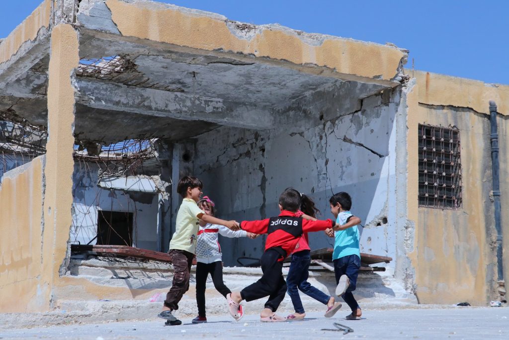 ch1362107 children playing outside their school idlib syria