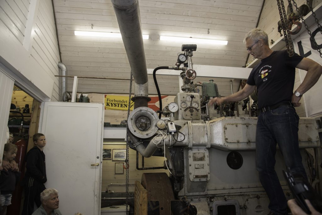Kortreiste gleder ved Trysfjorden 10 Mega motor: Thor Borø fyrte opp denne dieselmotoren med trykkluft. Det gikk ikke lydløst for seg.-Den veier åtte-ni tonn, har tre sylindre og den har vært hjelpemotor på hurtigruteskipet M/S Lofoten, forteller Borø som er utdannet maskinist. Kystlaget har ellers en anselig samling båtmotorer av fin gammel årgang stående i grendehuset.